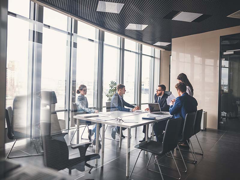 professionals around a office table.